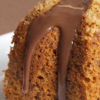 Close-up of hazelnut cake with chocolate syrup.