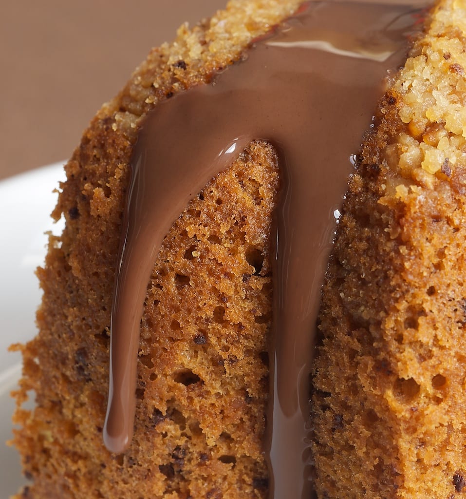 Close-up of hazelnut cake with chocolate syrup.