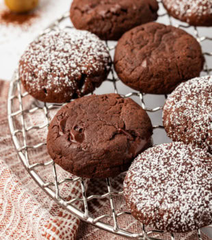 Cooling rack with chocolate espresso cookies; some dusted with powdered sugar