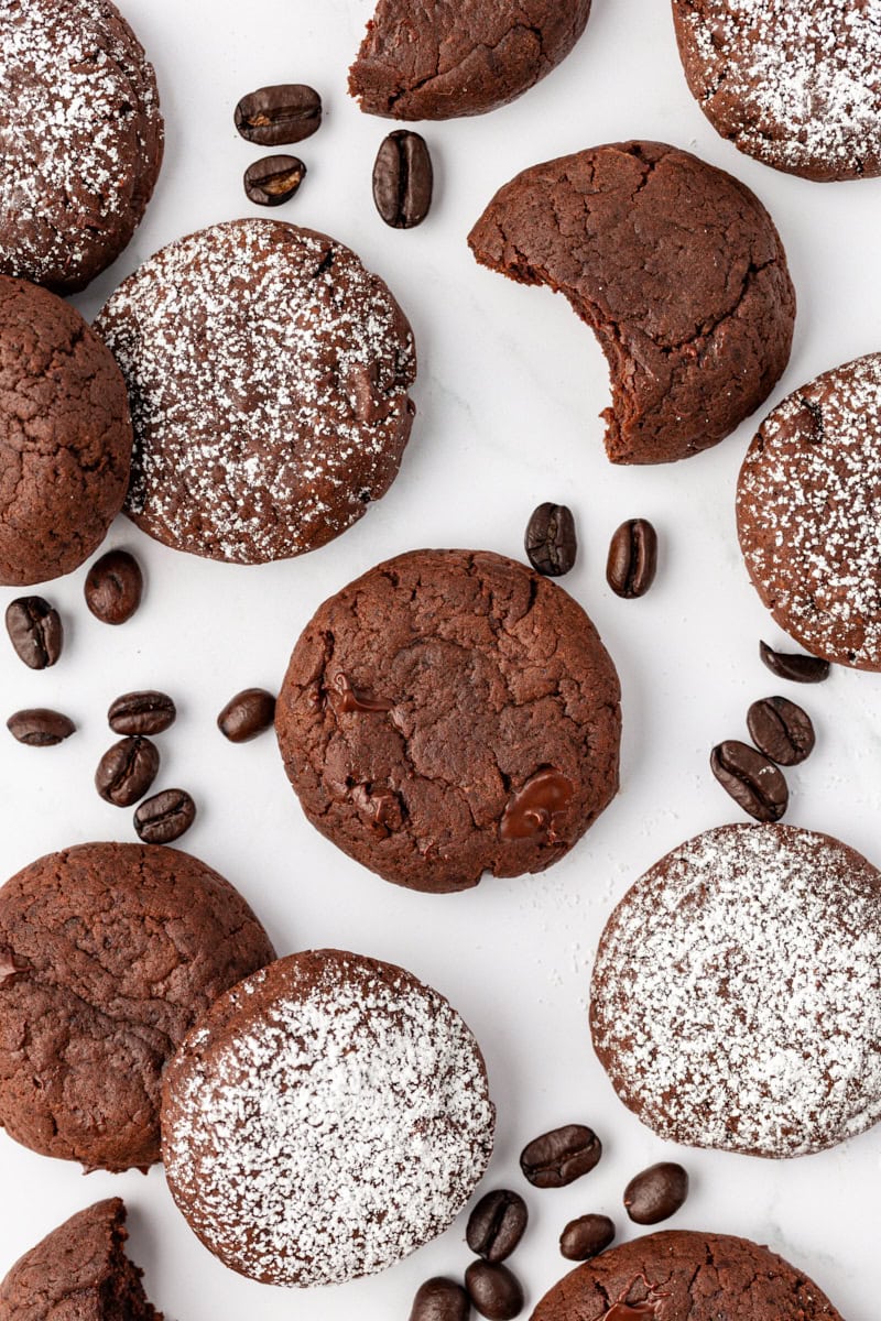 Overhead view of chocolate espresso cookies and coffee beans on countertop