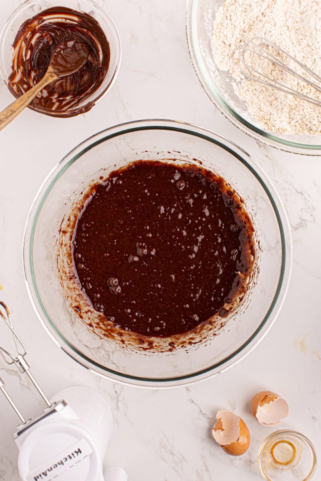 Overhead view of wet ingredients for chocolate butterscotch cookies in bowl