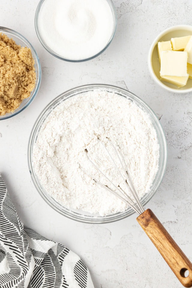 Overhead view of dry ingredients in bowl with whisk