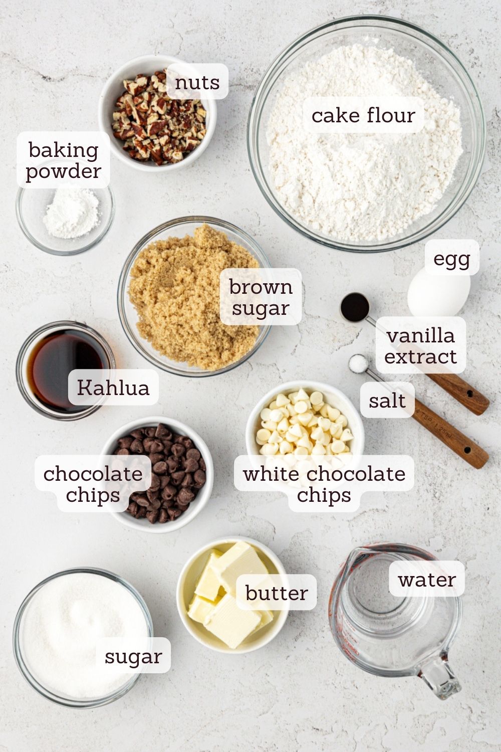Overhead view of ingredients for black and white chocolate chip cookies with labels