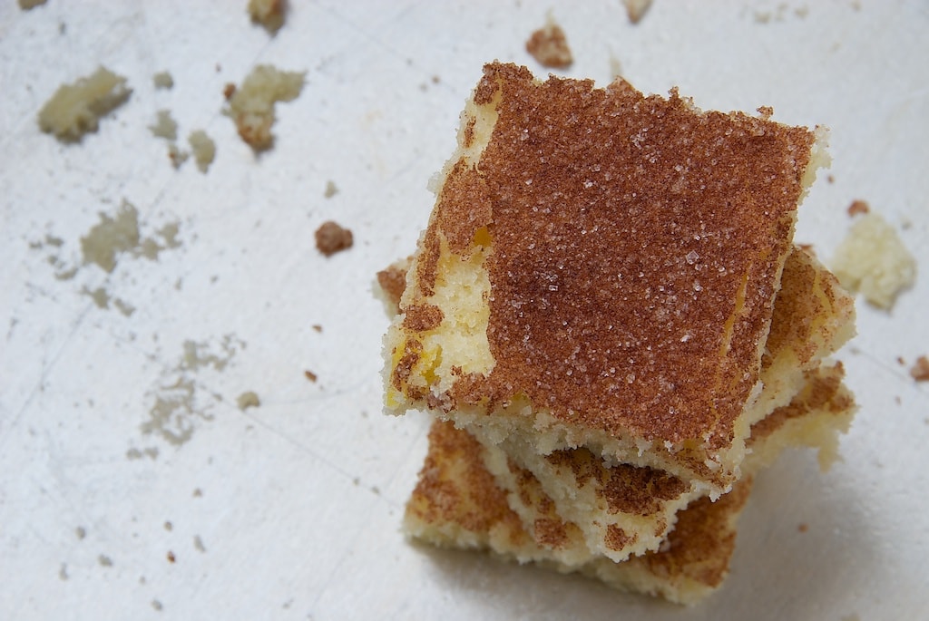 Crumbly cinnamon sugar cookie bars in a stack.