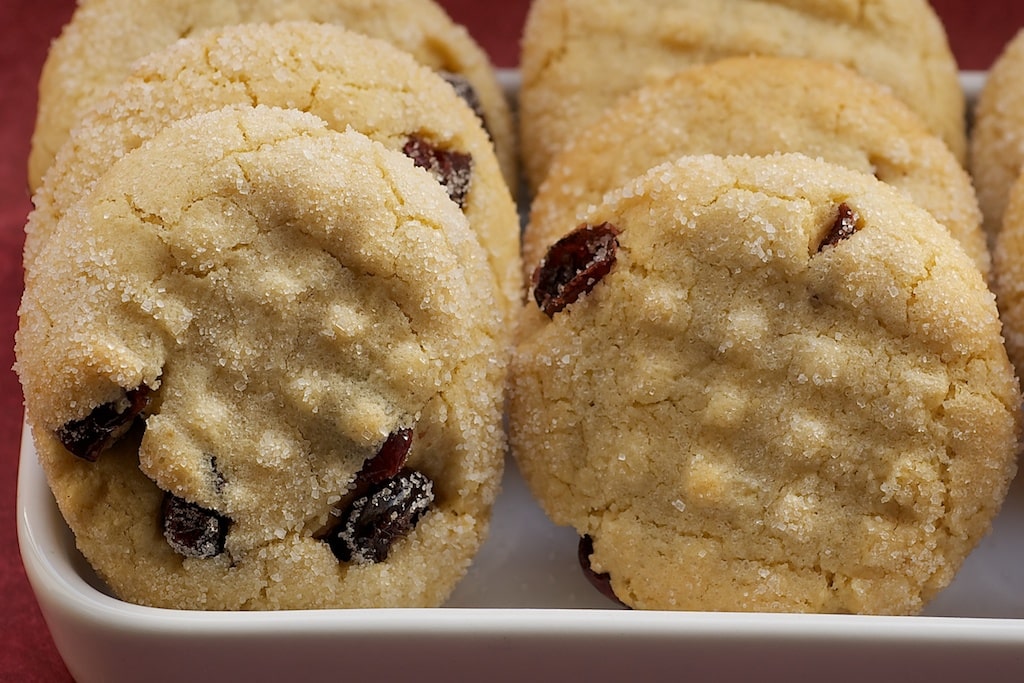 Macadamia Butter Cookies with Dried Cranberries neatly arranged in a white serving dish