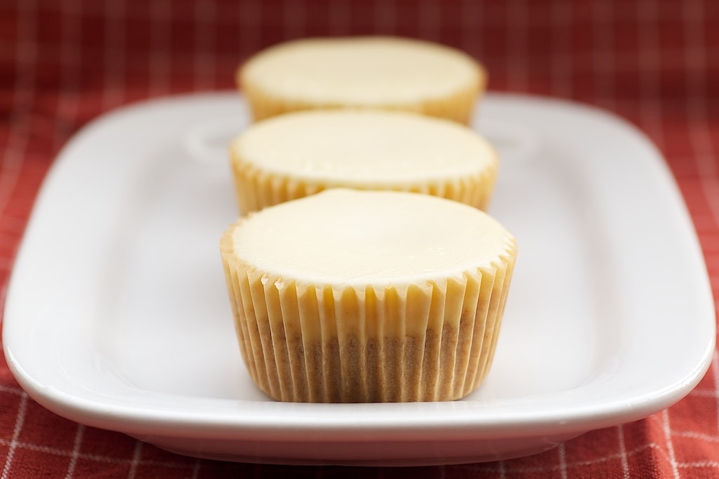 Peanut Butter Cheesecake Minis feature a peanut butter cup surprise inside miniature cheesecakes.