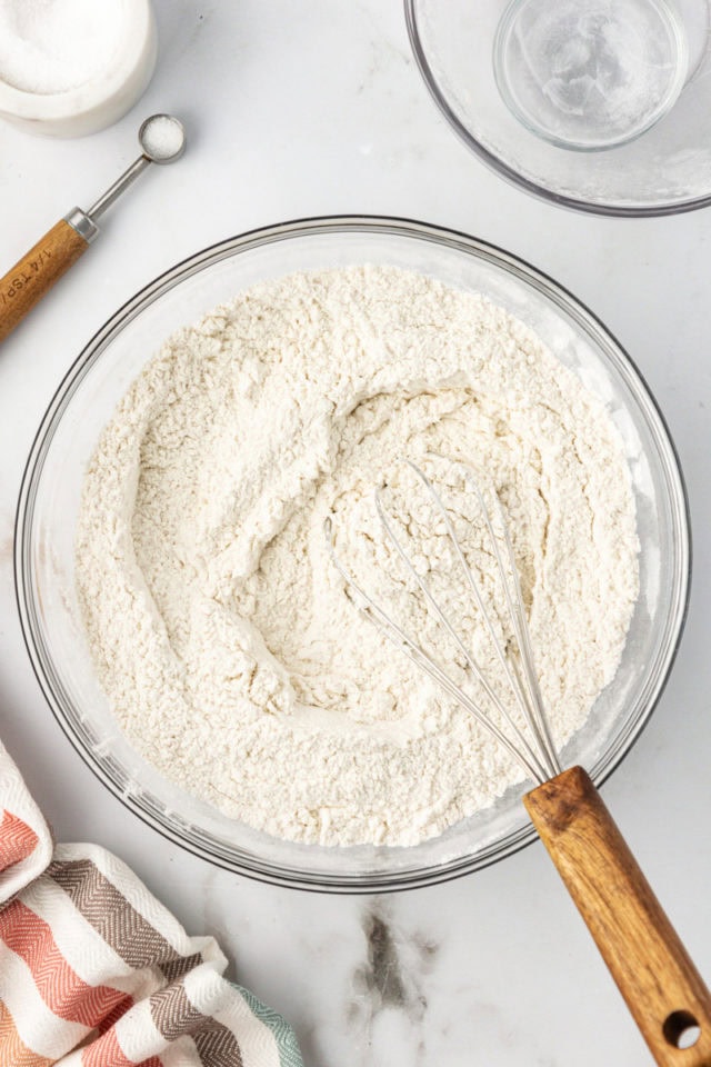 Overhead view of dry ingredients for blondies in bowl with whisk