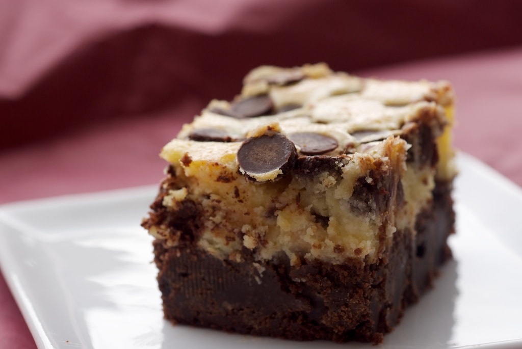 Black bottom brownie with chocolate chips on a plate.