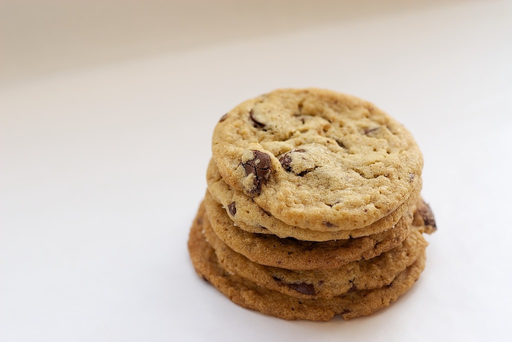 Peanut Butter Cookies with Milk Chocolate Chunks on a white surface