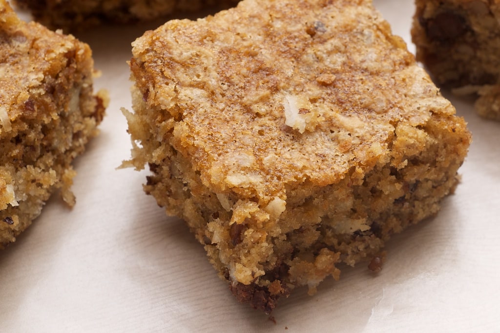 Coconut Pecan Blondies feature plenty of pecans, coconut, and brown sugar. A great quick and easy recipe that's a real crowd pleaser! - Bake or Break