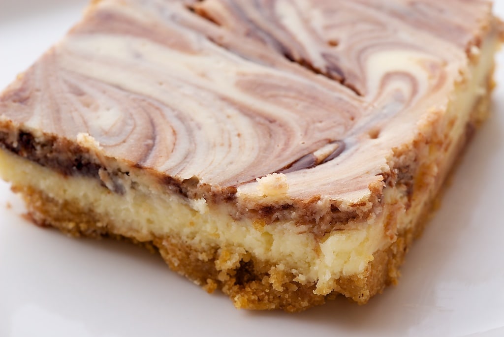 Nutella Swirl Cheesecake Bars feature a swirl of that favorite chocolate-hazelnut spread in sweet, rich cheesecake bars. - Bake or Break