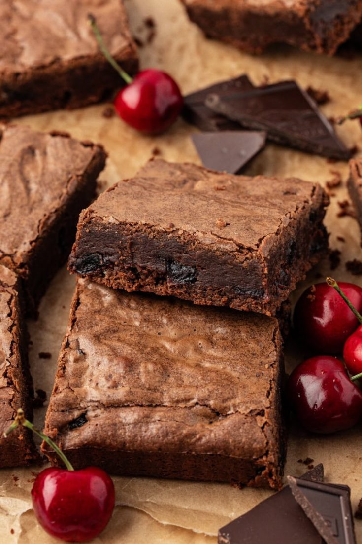 Dark chocolate sour cherry brownies on parchment paper