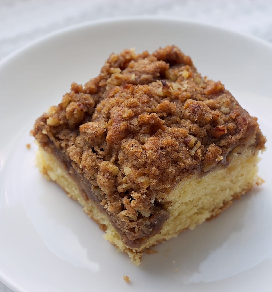 Cinnamon Cream Cheese Coffee Cake features a swirl of sweet cream cheese filling in a traditional coffee cake with a cinnamon-nut crumb topping.