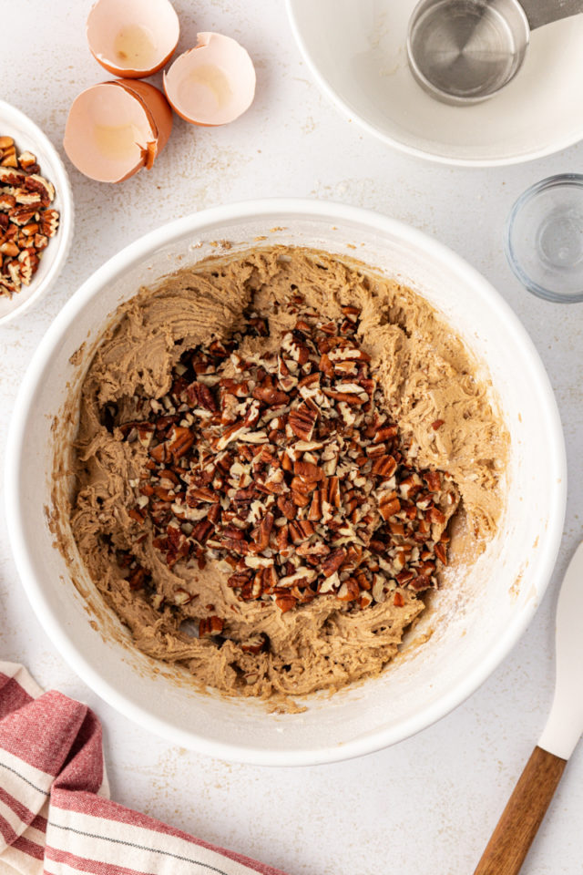 Pecans added to bowl of cookie dough