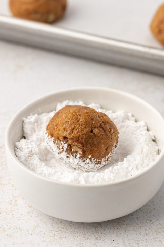 Rolling brown sugar cookie dough in powdered sugar