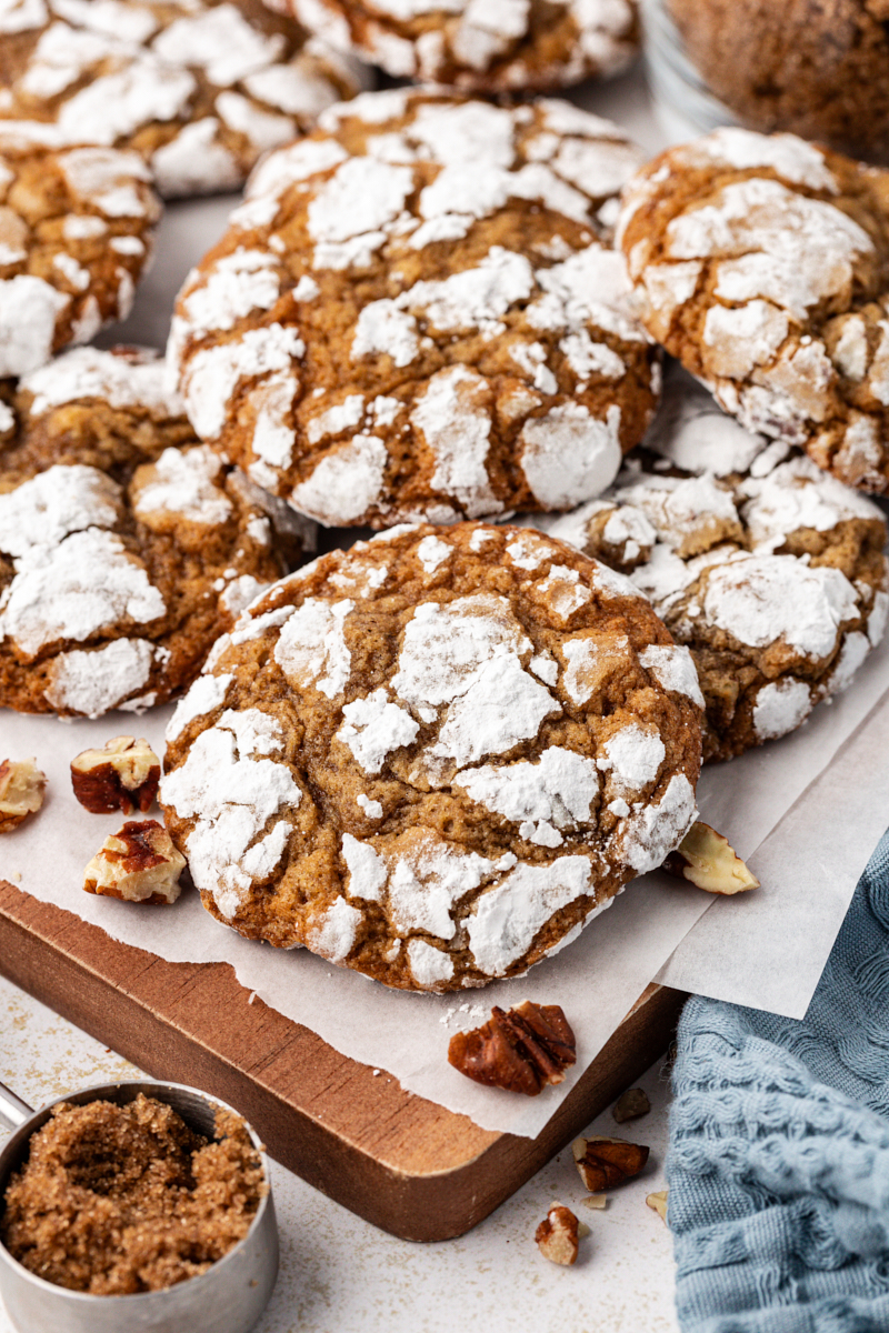 Stack of brown sugar crinkle cookies on parchment lined board