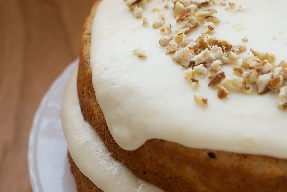 Pecan Layer Cake with Banana Icing topped with chopped pecans