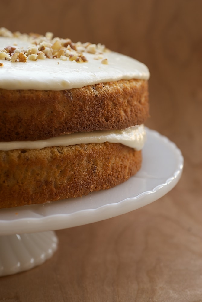 Pecan Layer Cake with Banana Icing on a milk glass cake stand