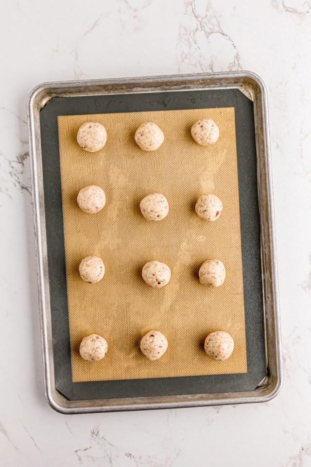 Overhead view of cream cheese shortbread dough balls on baking sheet