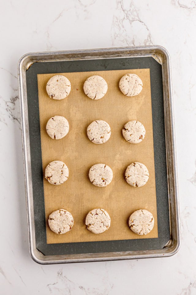 Overhead view of cream cheese shortbread on silplat-lined baking sheet