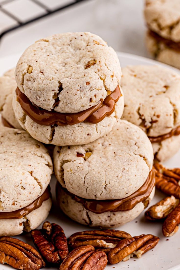 Stack of cream cheese shortbread sandwich cookies on plate