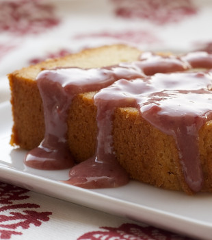 Cream Cheese Pound Cake with Strawberry-White Chocolate Sauce on a white plate.