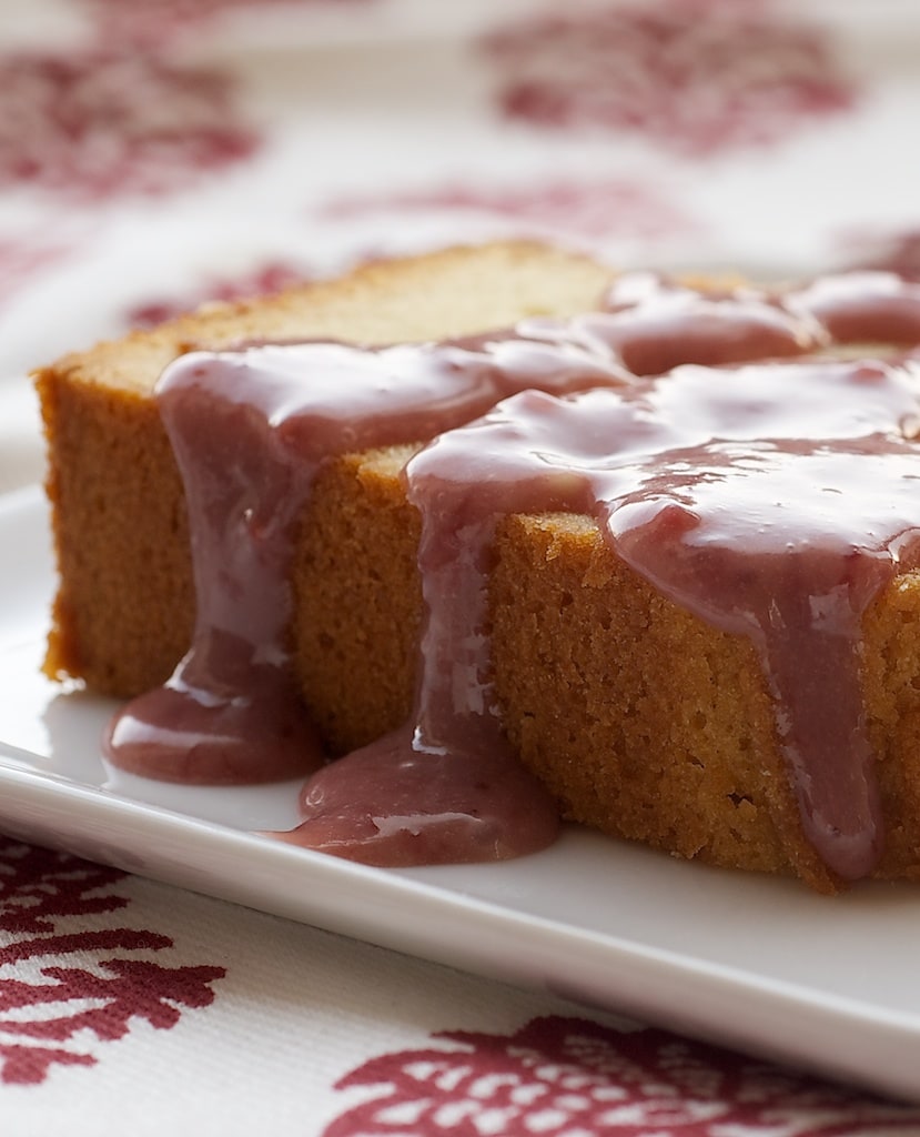 Cream Cheese Pound Cake with Strawberry-White Chocolate Sauce on a white plate.