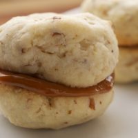 Cream Cheese Shortbread-Dulce de Leche Sandwich Cookies combine a soft, light, nutty shortbread with rich dulce de leche for an irresistible cookie. - Bake or Break