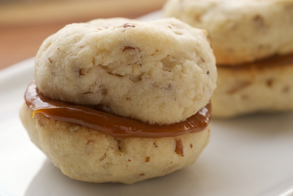 Cream Cheese Shortbread-Dulce de Leche Sandwich Cookies combine a soft, light, nutty shortbread with rich dulce de leche for an irresistible cookie. - Bake or Break