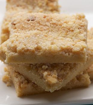 Stacked macadamia shortbread on a white plate.