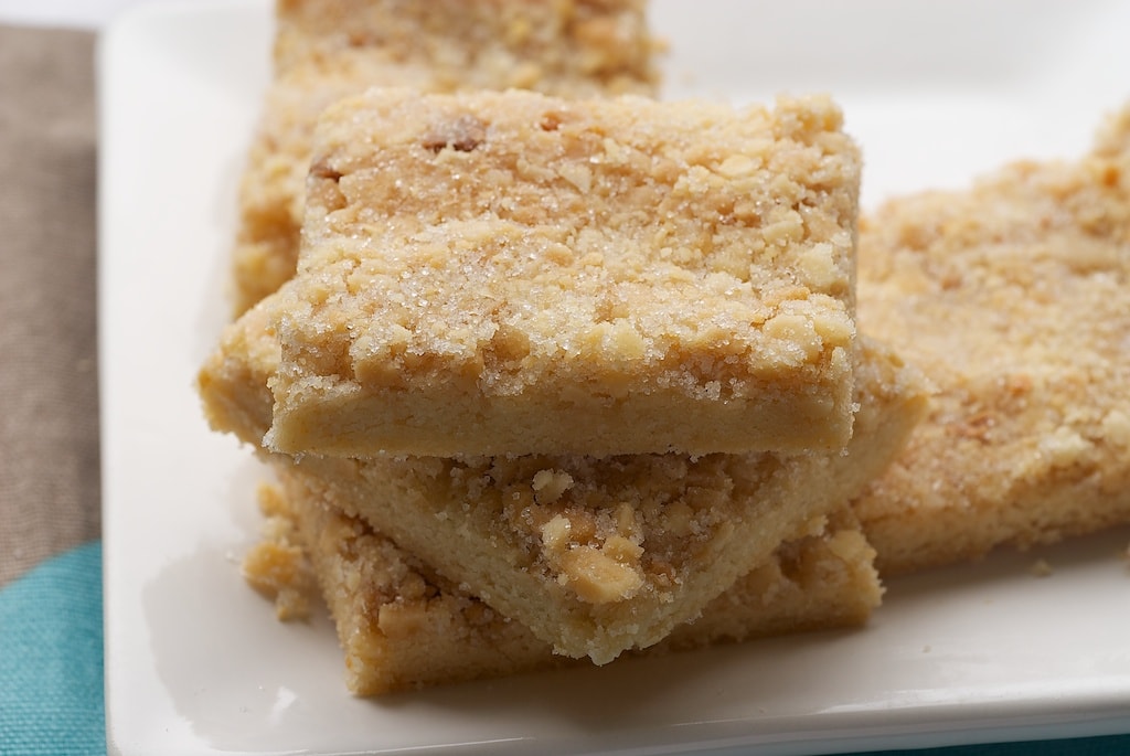 Stacked macadamia shortbread on a white plate.