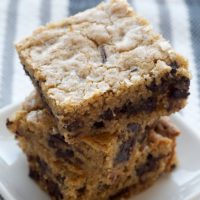 Salty Chocolate Chunk Blondies stacked on a white plate