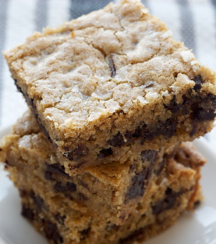 Salty Chocolate Chunk Blondies stacked on a white plate