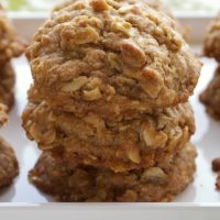 Toffee-Almond Oatmeal Cookies stacked on a white tray