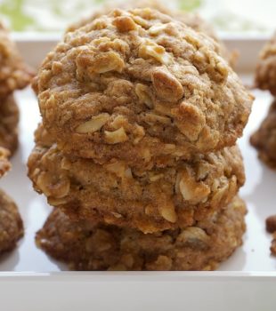 Toffee-Almond Oatmeal Cookies stacked on a white tray