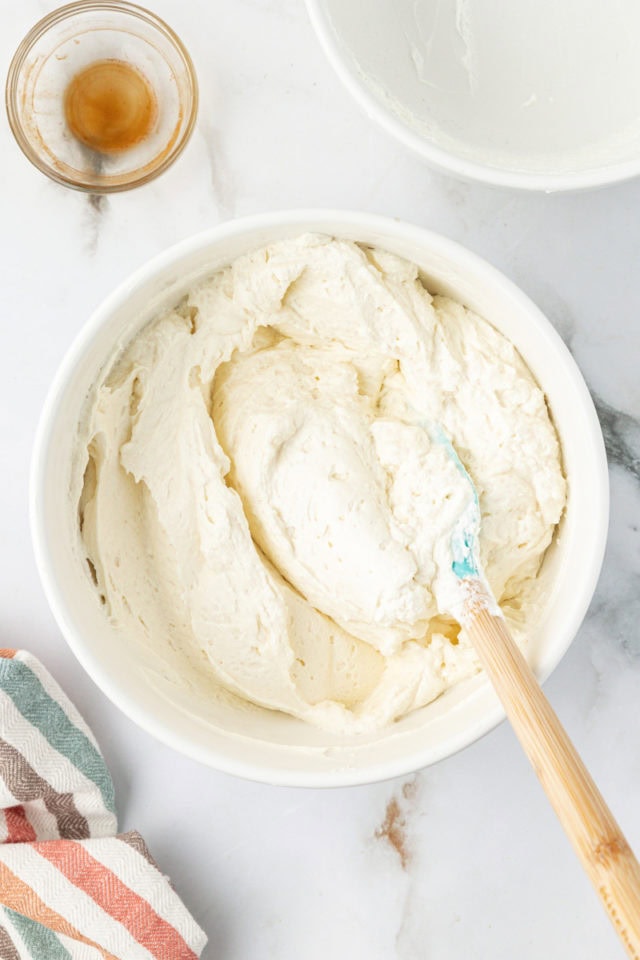 Overhead view of no bake cheesecake mixture in mixing bowl