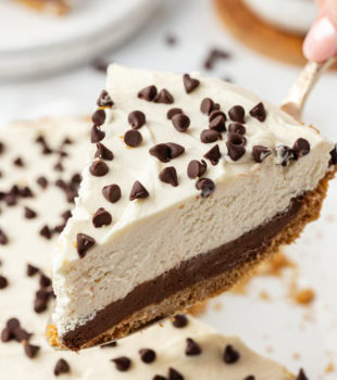 Lifting slice of chocolate cookie dough cheesecake
