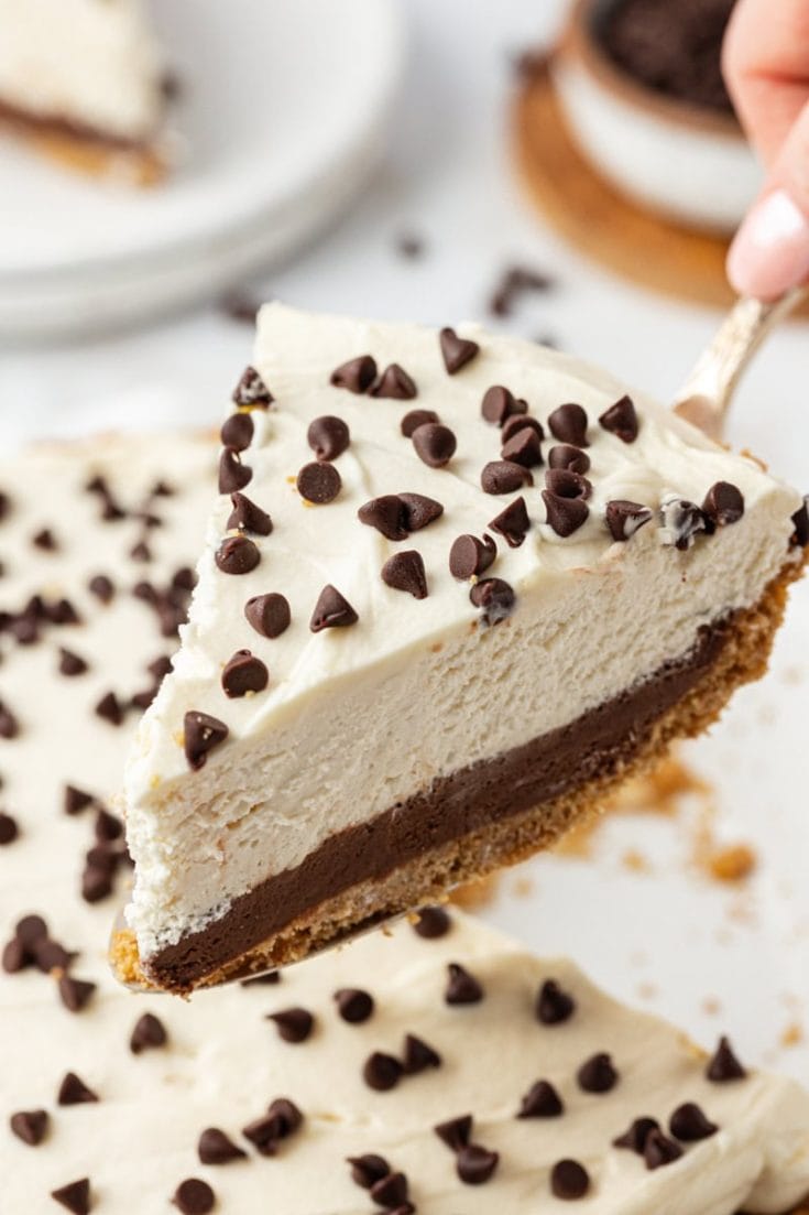 Lifting slice of chocolate cookie dough cheesecake