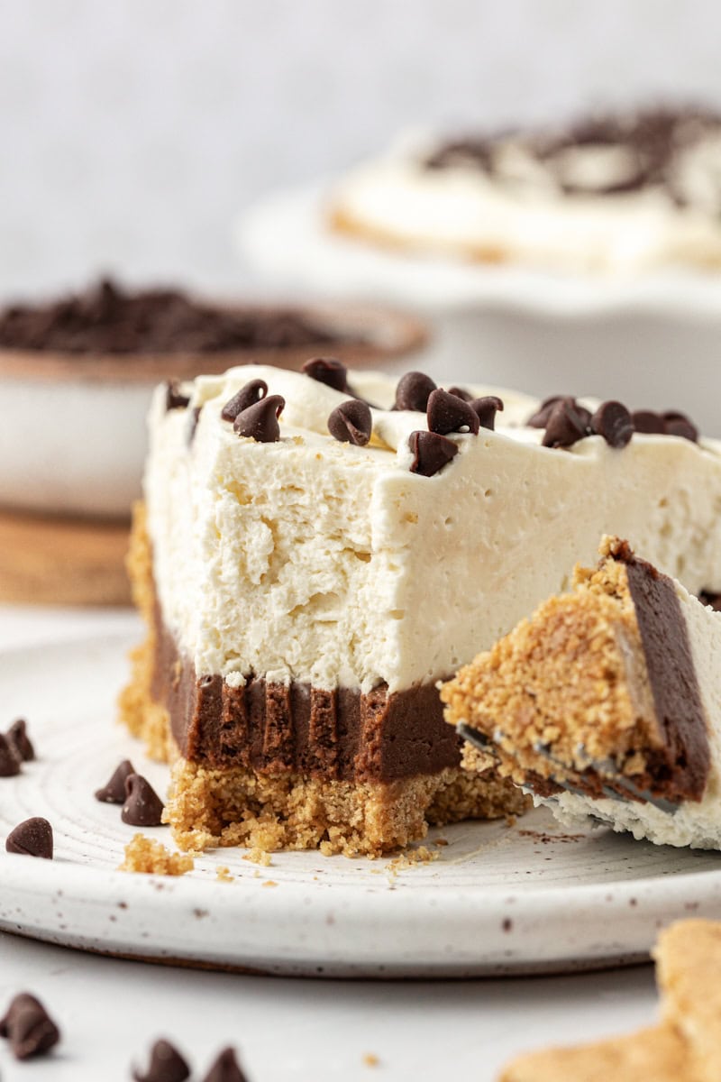 Closeup of chocolate cookie dough cheesecake on plate with tip on fork