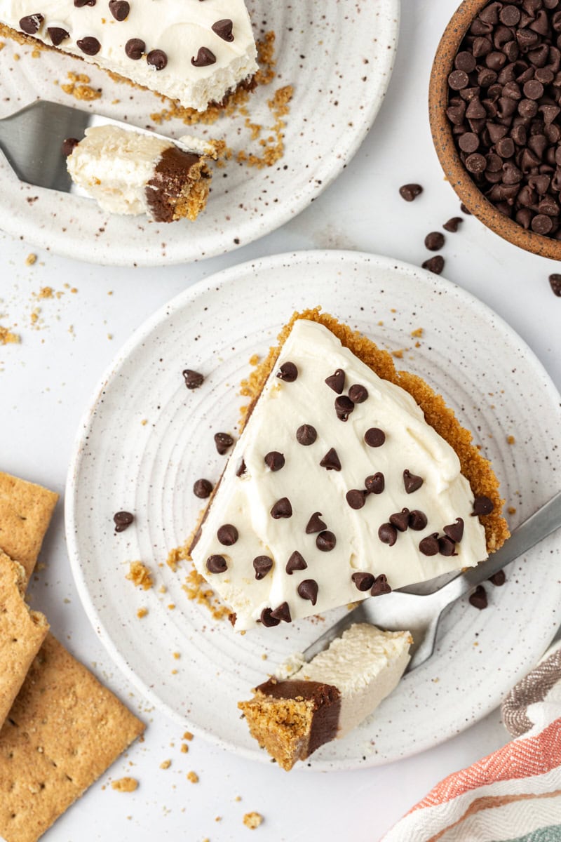 Overhead view of chocolate cookie dough cheesecake slice on plate with tip of cake on fork