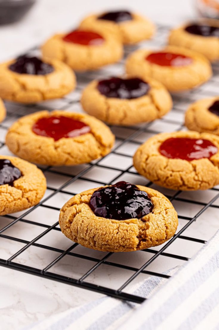 Wire rack with peanut butter and jelly thumbprint cookies