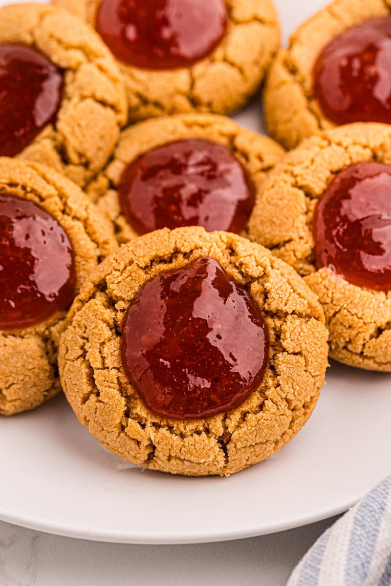 Plate of peanut butter and jelly thumbprint cookies with strawberry jam