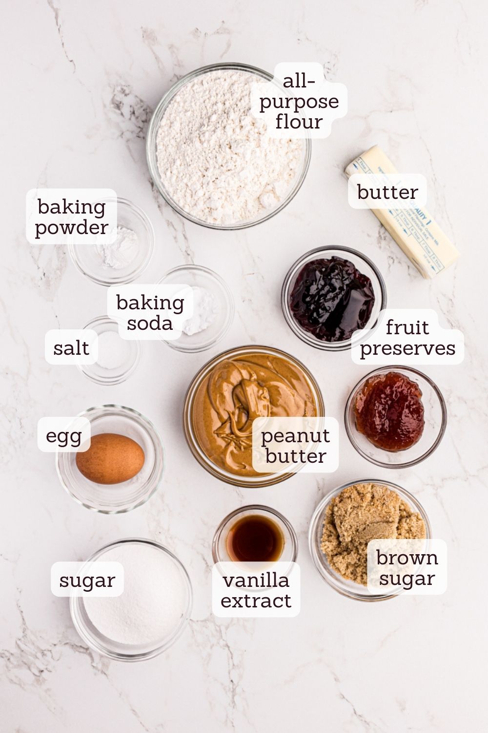 Overhead view of ingredients for peanut butter and jelly thumbprint cookies with labels