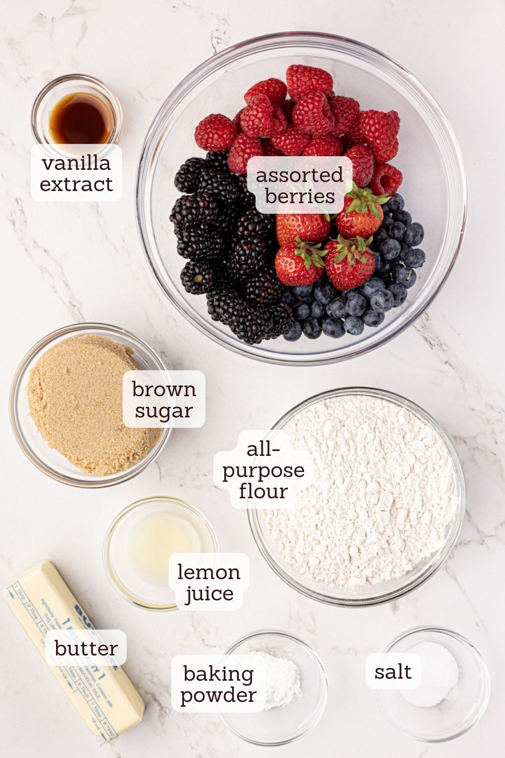 Overhead view of ingredients for mixed berry cobbler with labels