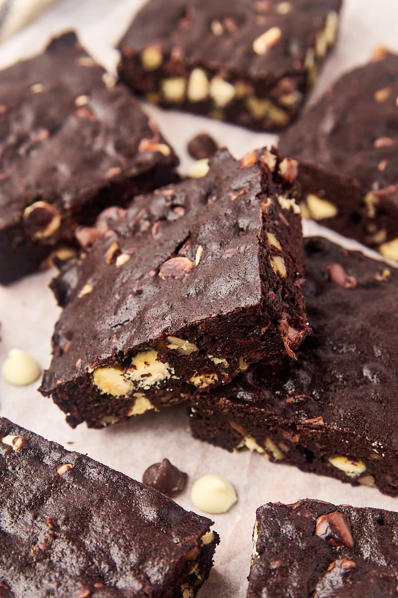 Decadent triple chocolate brownies on parchment paper