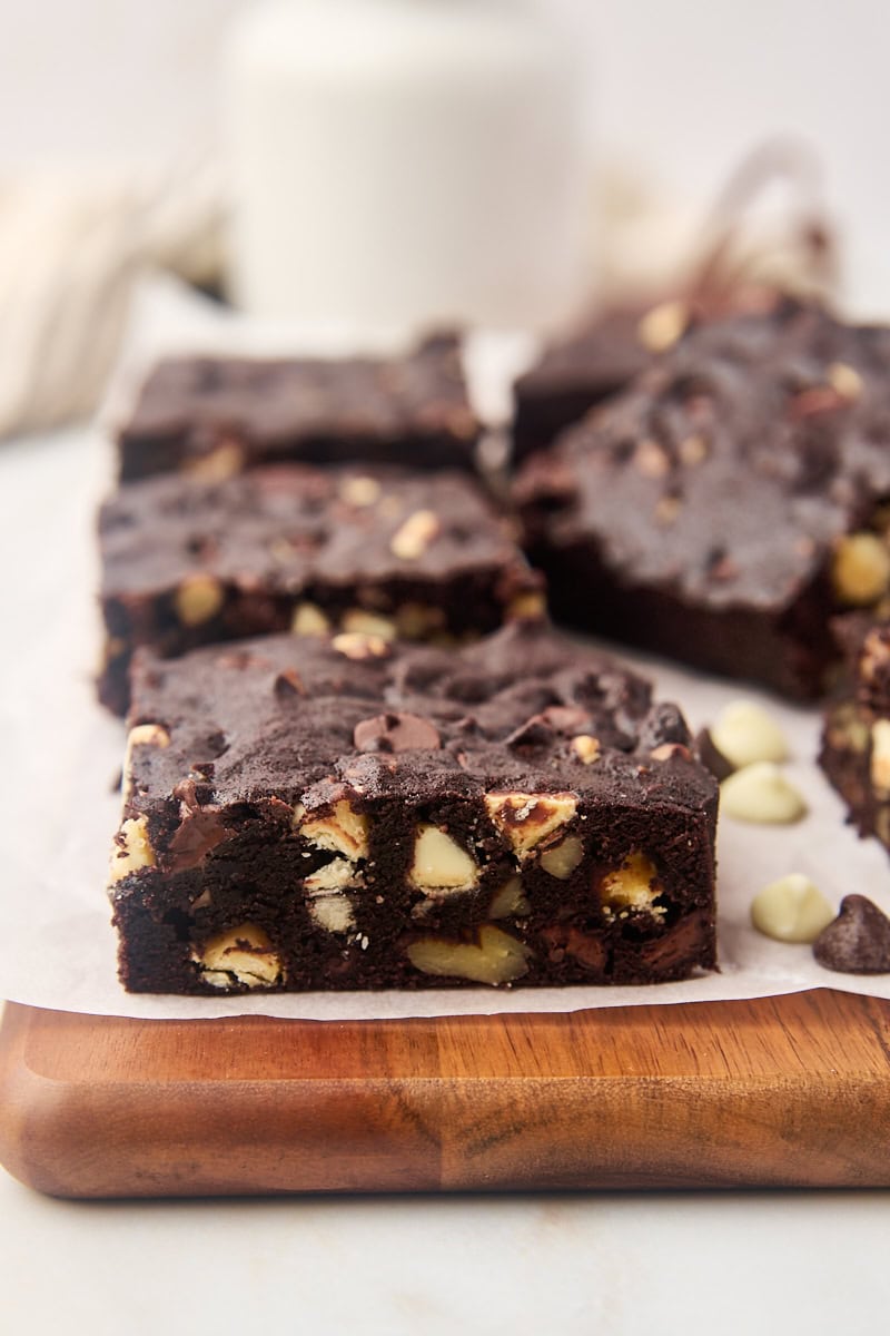 Fudgy triple chocolate brownies on cutting board