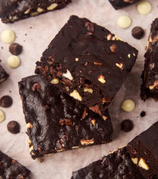 Triple chocolate brownies on parchment paper