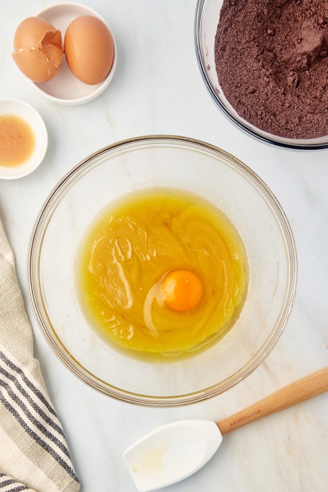 Egg added to wet ingredients in mixing bowl