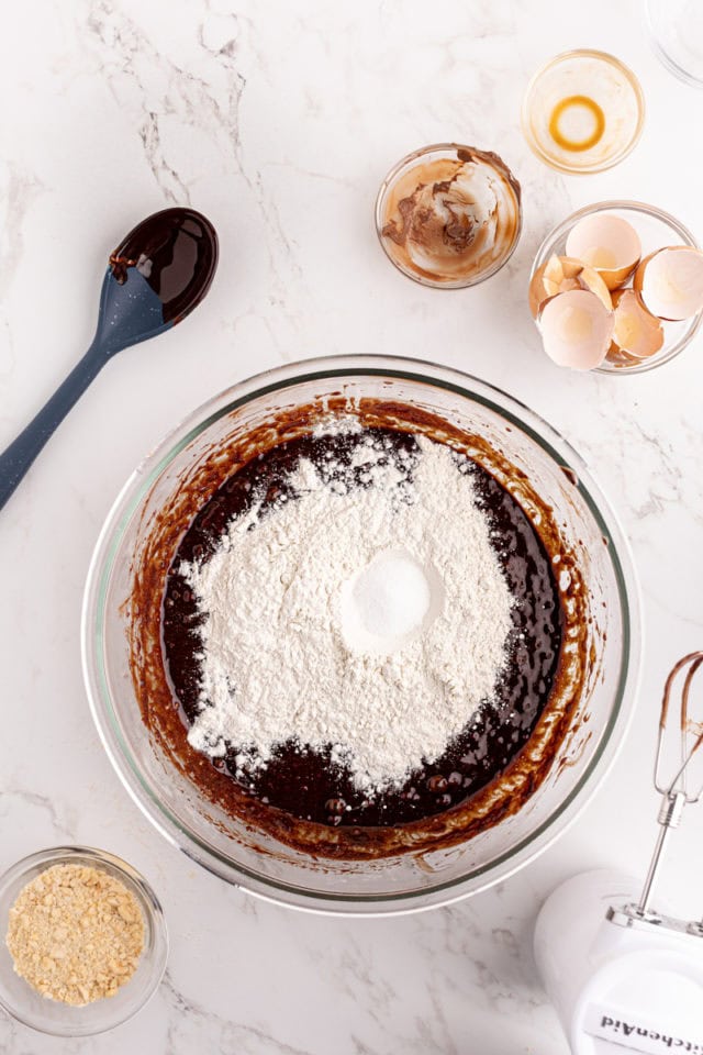 Overhead view of flour and salt added to brownie batter