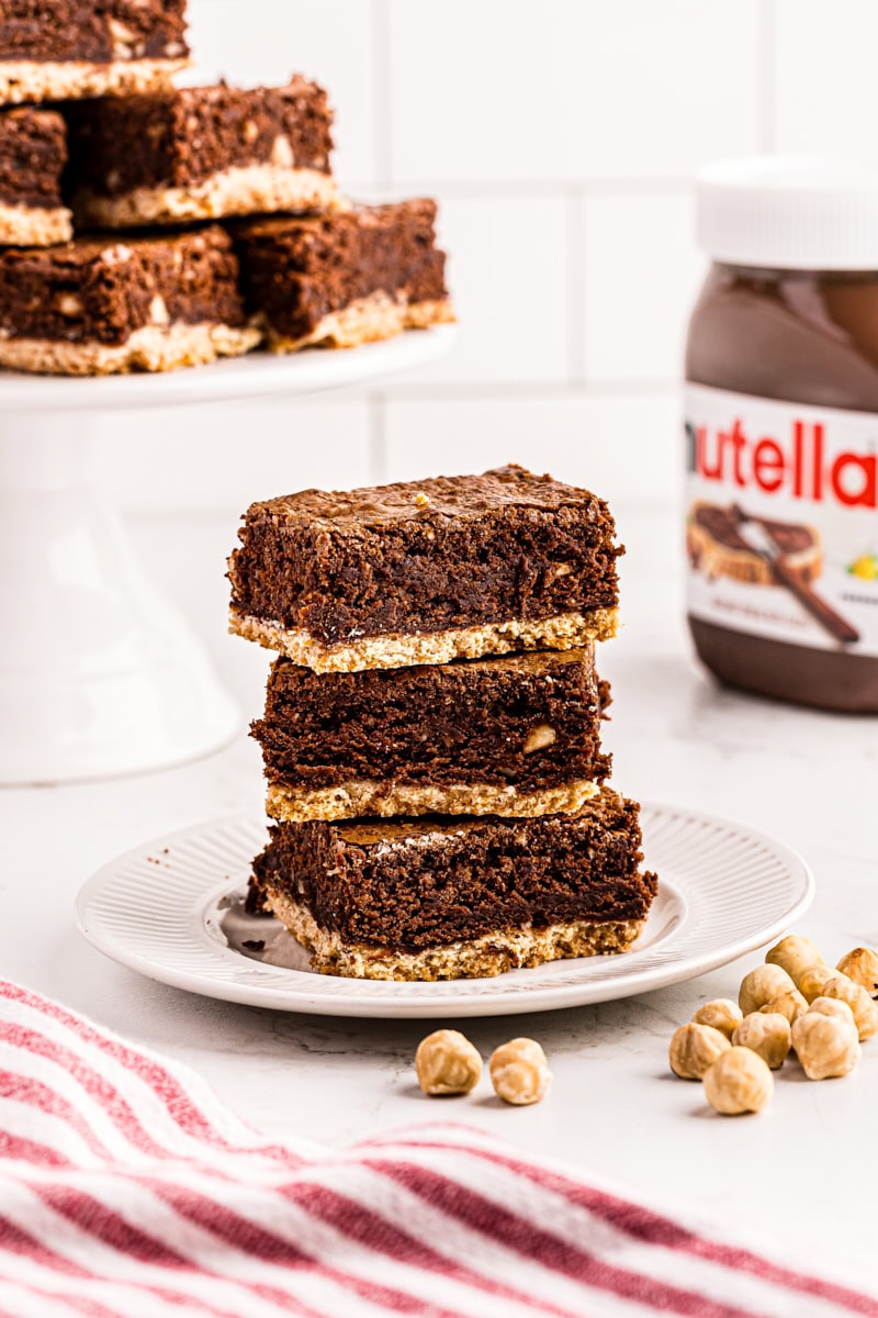 3 Nutella brownies stacked on white plate